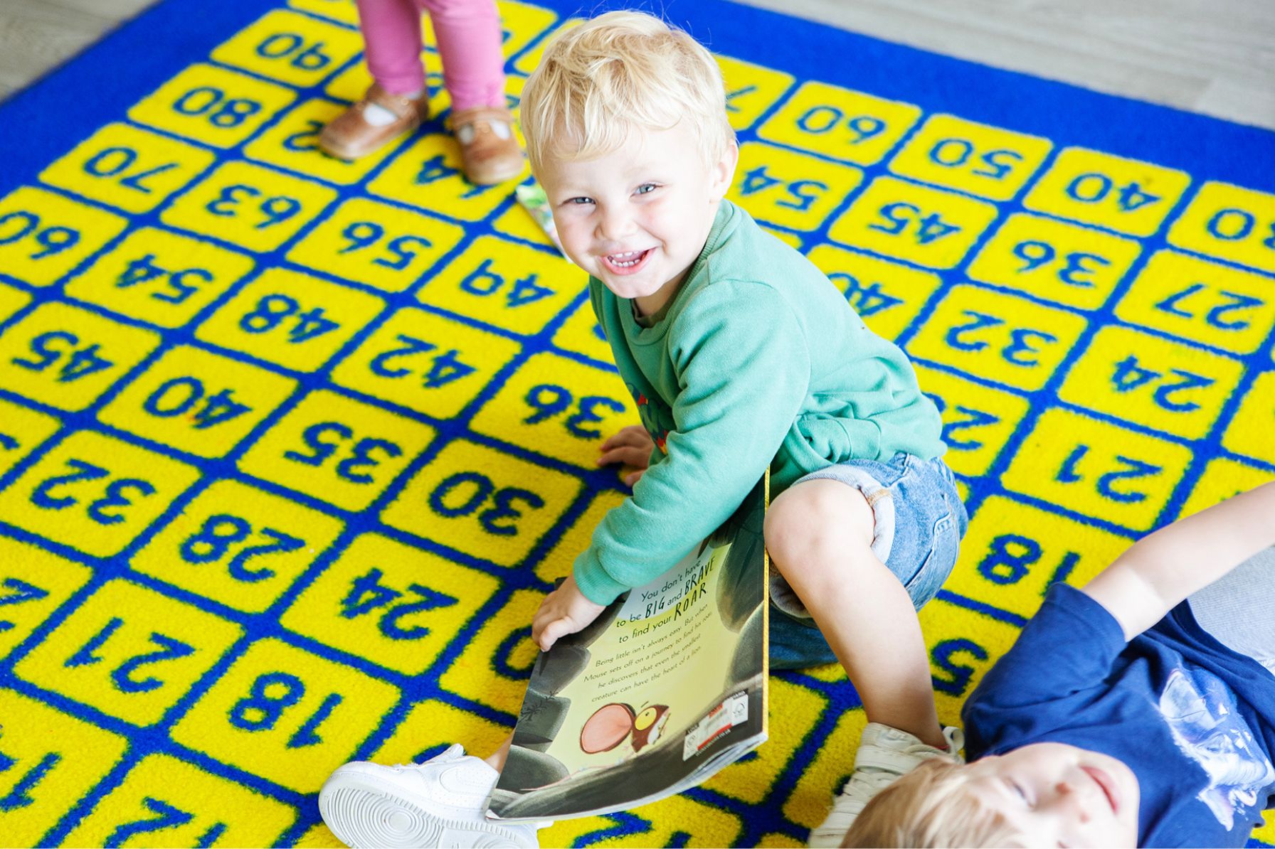 Happy child playing at Garden Cottage Nursery in Canterbury