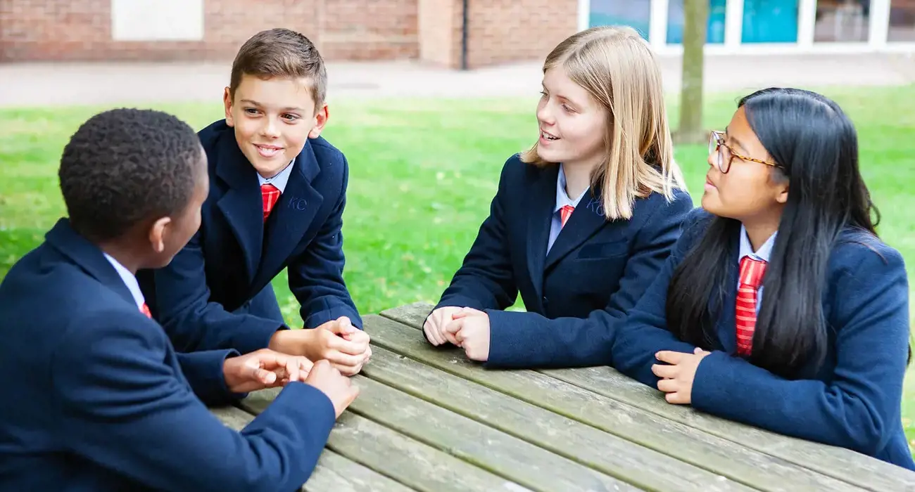 Kent College Canterbury Junior School students relaxing together outside